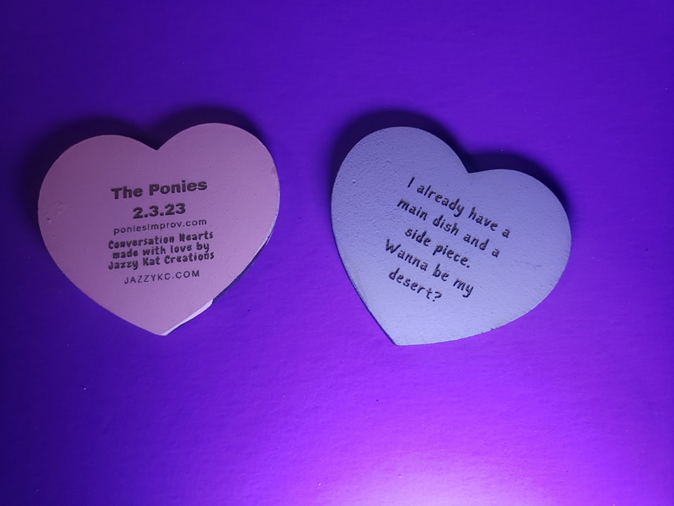 custom conversation hearts made from laser cut wood with inscriptions suggested by Ponies members